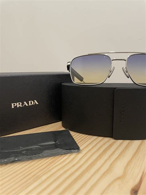 Prada Sunglasses with Iconic Metal Plaque SPR67Z .